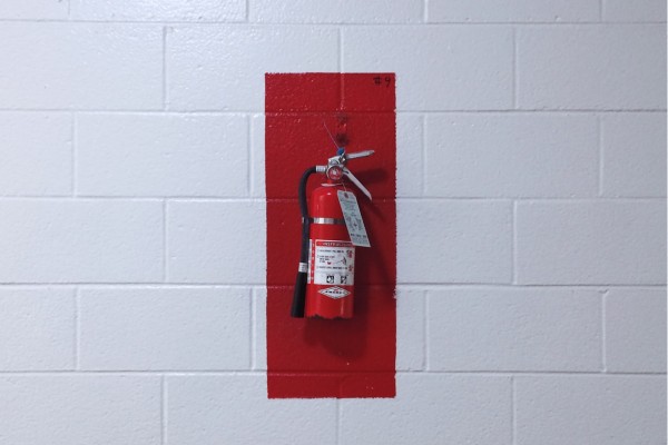 red fire extinguisher on wall